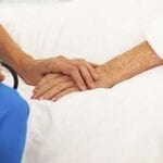 Doctor holding patient's hand